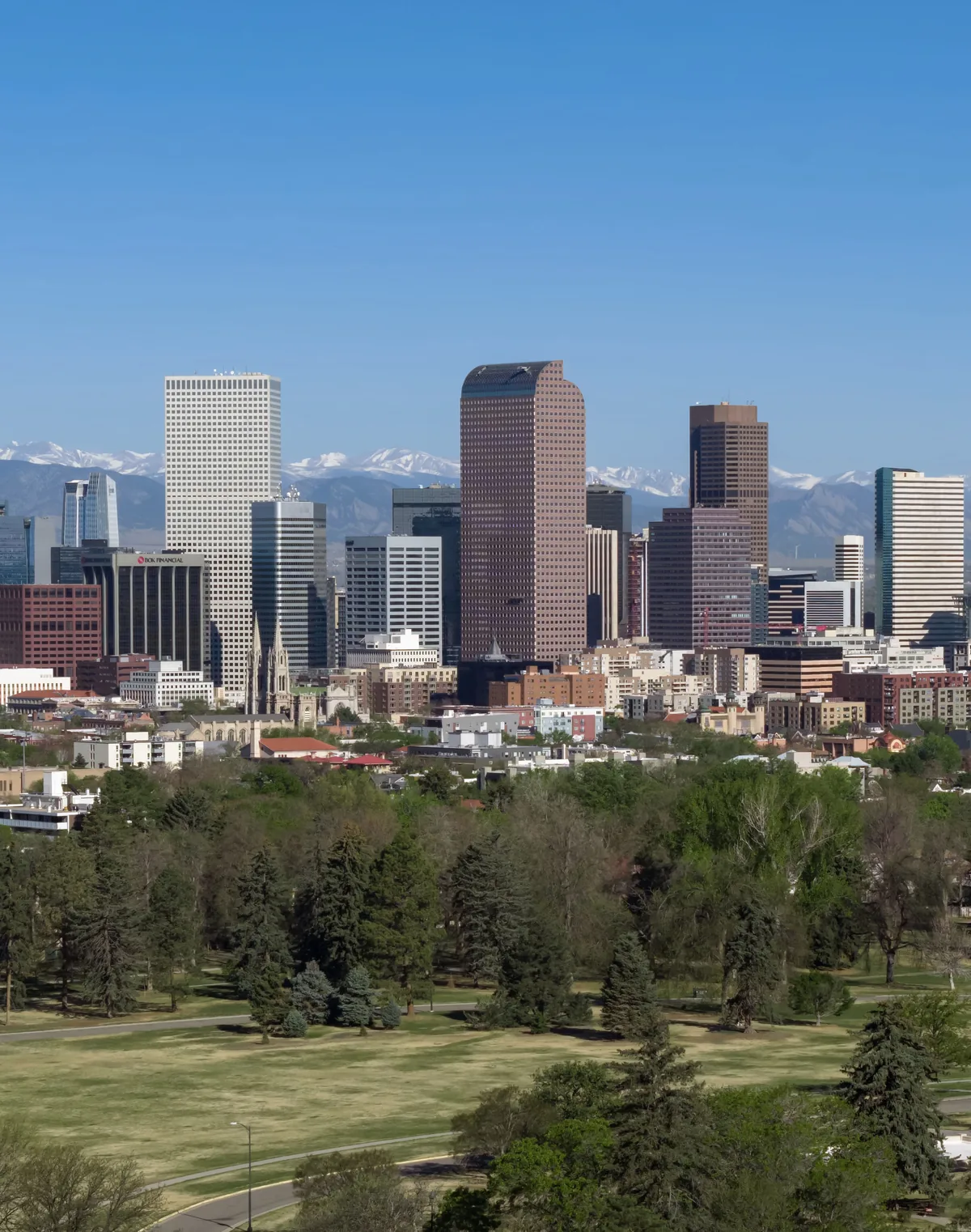 The downtown Denver, Colorado skyline with the Rocky Mountains behind it